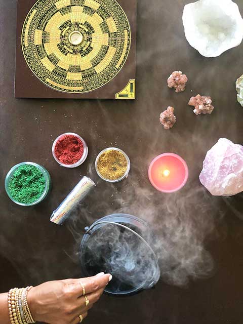 burning incense with rose quartz and selenite crystals nearby
